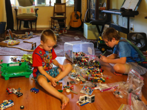 Two boys with toys on the floor