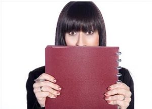 woman hiding behind folder